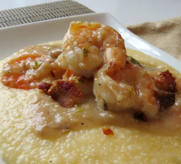 Shrimp and grits with creamy sauce and bacon, a hearty fall seafood dish.