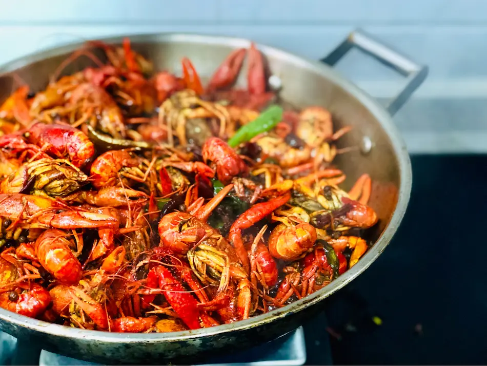 Sustainable seafood, such as the crawfish in a stainless steel skillet pictured here, are beneficial to the aquatic ecosystem and your health.