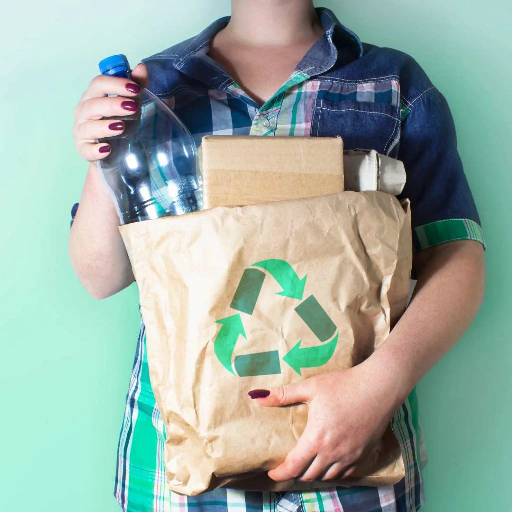 Man getting ready to recycle plastic