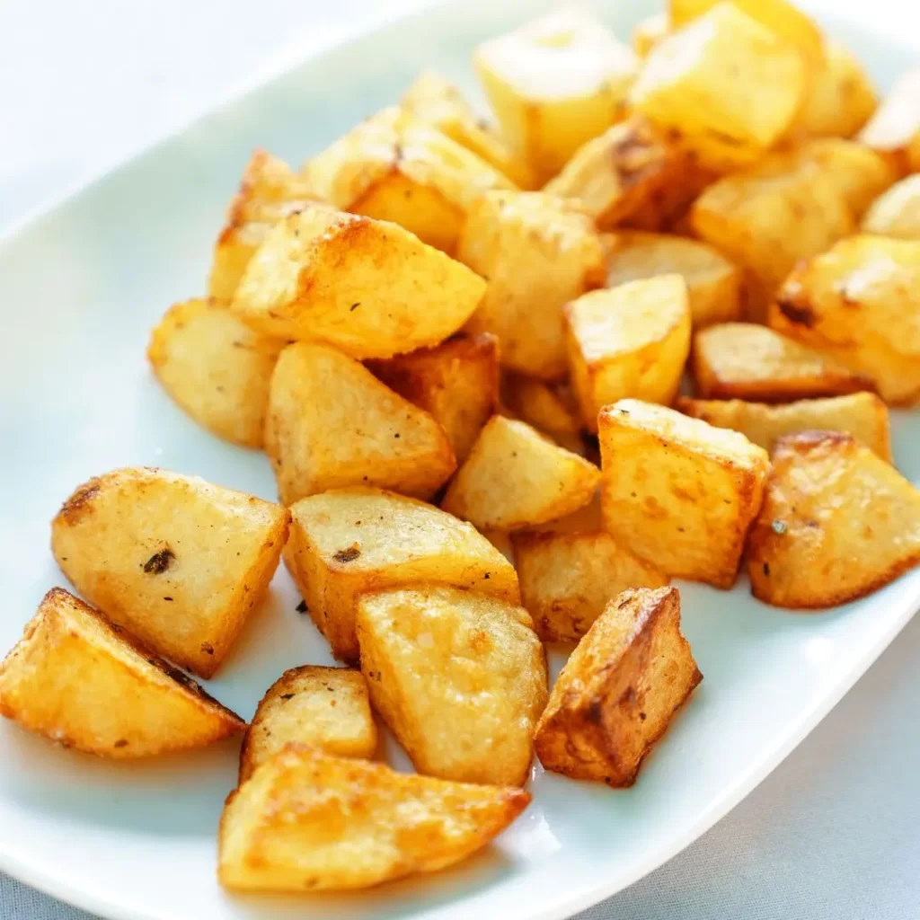 Sides to serve with scallops includes roasted potatoes on a plate, as shown here.